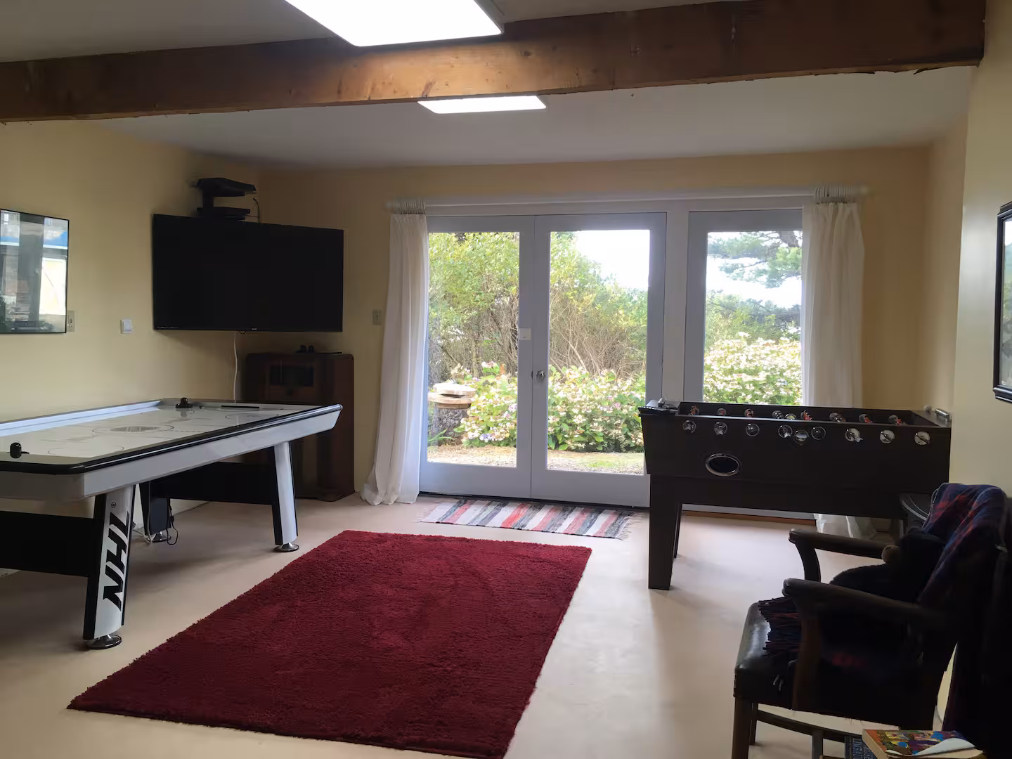 Downstairs game room with air hockey and foosball